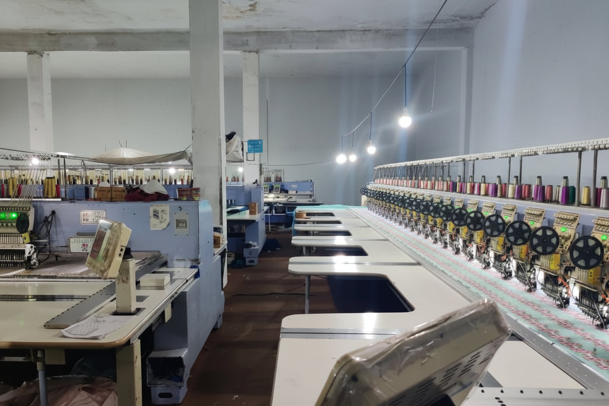 Textile factory interior with sewing machines and equipment.